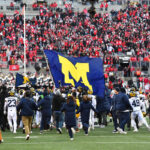 Sherrone Moore does flag-planting gesture at Michigan basketball game, one week after beating Ohio State