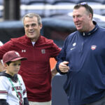 South Carolina coach Shane Beamer has to be restrained after Illinois’ Bret Bielema makes substitution gesture towards USC sideline