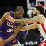 Suns star Kevin Durant helped off court after injuring left leg