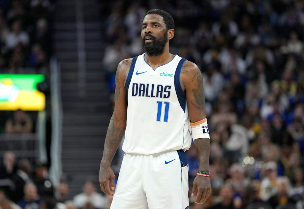 Mavericks star Kyrie Irving helped off the floor after awkward knee injury early in matchup with Kings