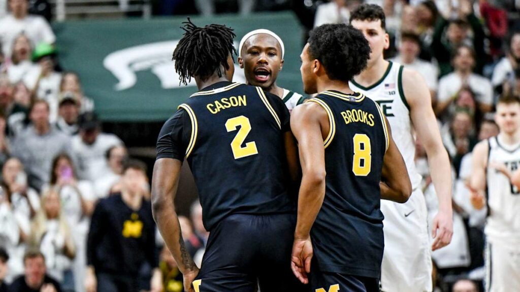 Michigan, Michigan State players shove one another at center court late in game