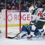 Wild inch closer to playoff berth, rallying to beat the Canucks 3-2 in OT