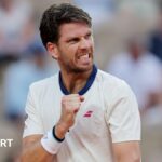 French Open 2025: Cameron Norrie beats Jacob Fearnley in match disrupted by Champions League fireworks